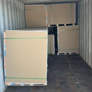 Large cardboard boxes packed inside a shipping container, organized neatly for transportation.