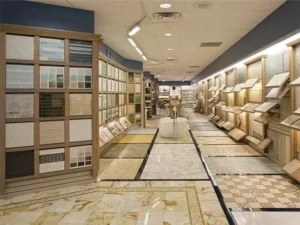 Numerous tile samples displayed on shelves and walls in a showroom, showcasing a variety of colors and patterns under bright lighting.
